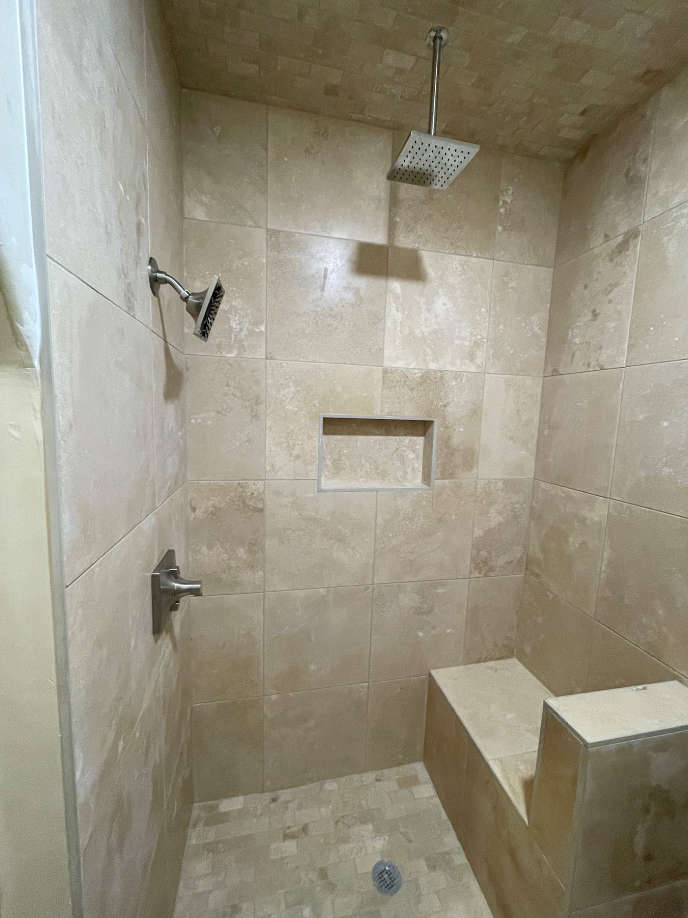 Custom tile shower with bench and niche