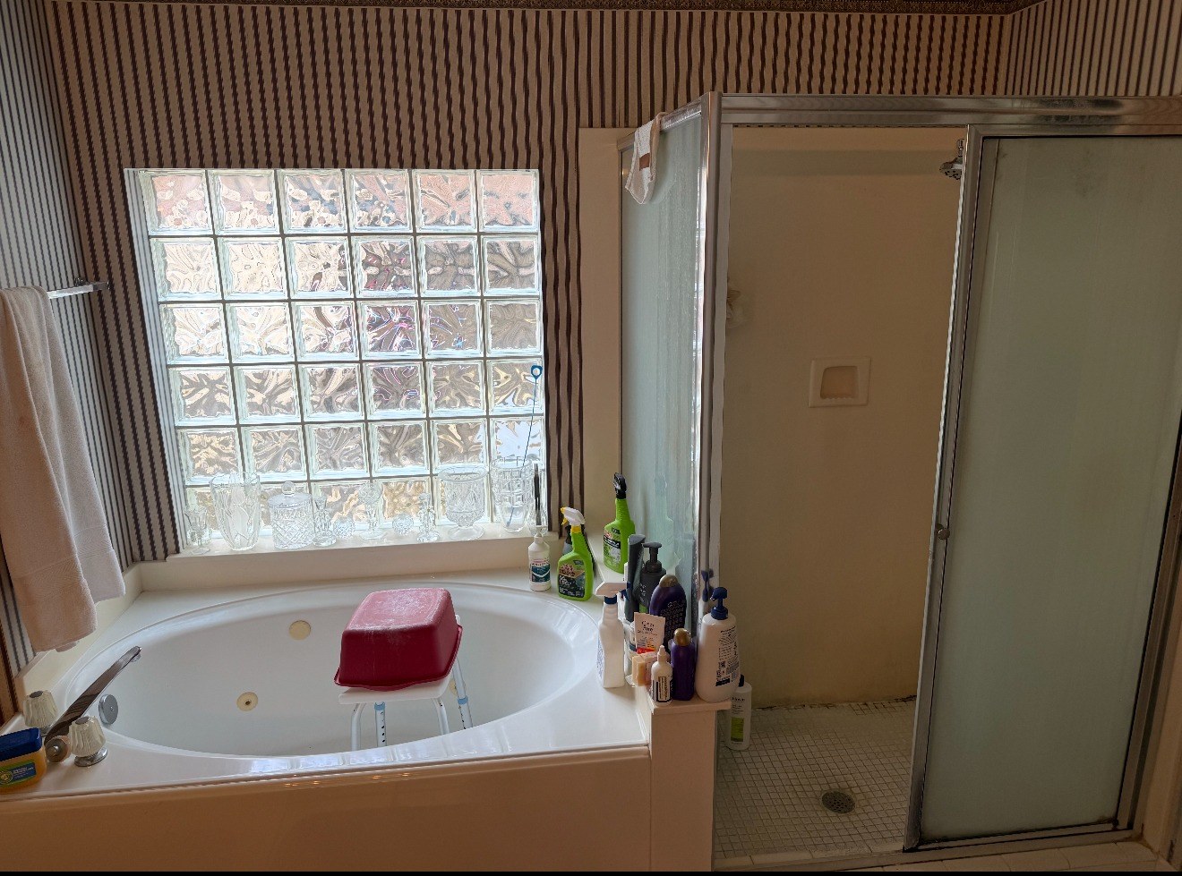 Bathroom before renovation with corner tub and enclosed shower